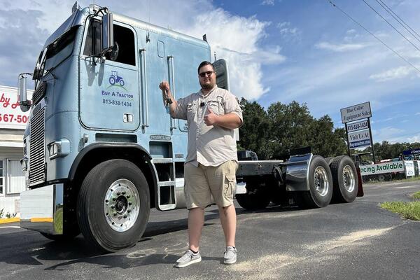 Commercial truck buyers purchase confidence, not only equipment Truck seller showing maintenance records and vehicle specifications to potential buyer during Facebook truck sale process
