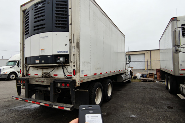 Refrigerated trucks are essential when freight must remain within a controlled temperature range during transportation Chinese refrigerated truck buyer inspecting a reefer trailer refrigeration unit and insulated cargo compartment at a North American truck yard