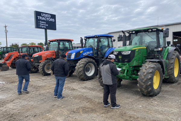 Different used tractors including compact tractors, utility tractors, cab tractors, and high-horsepower agricultural tractors displayed for buyers to compare